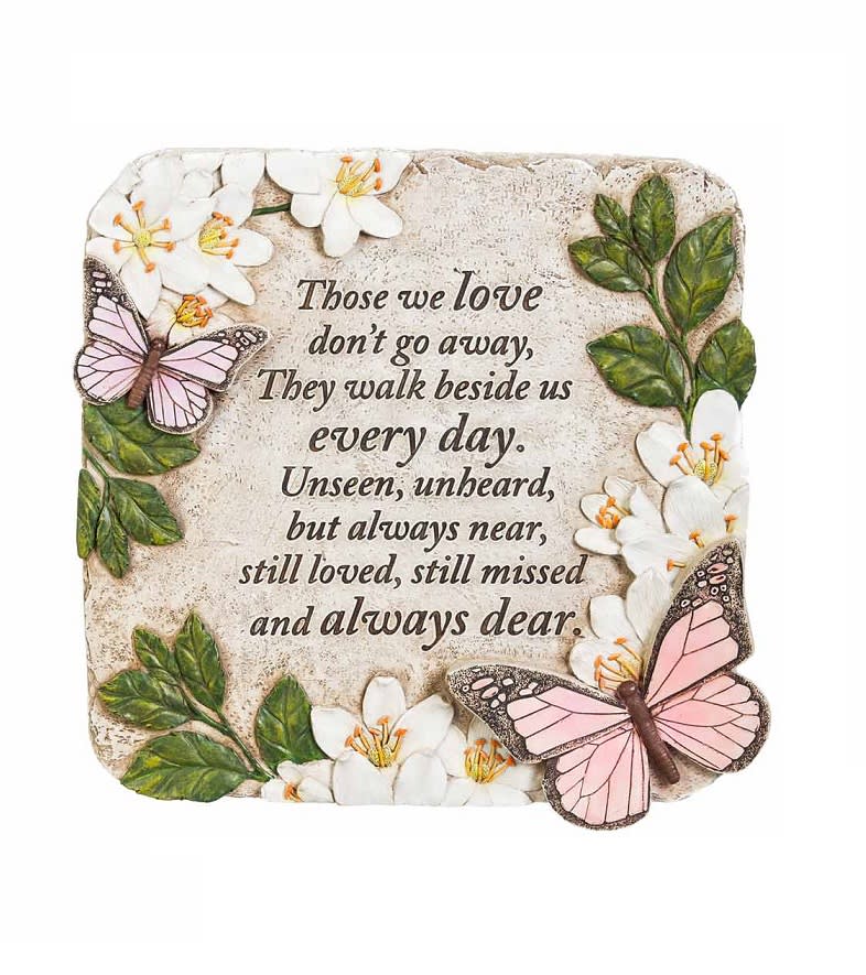 Decorative memorial plaque with flowers, butterflies, and a sympathy quote