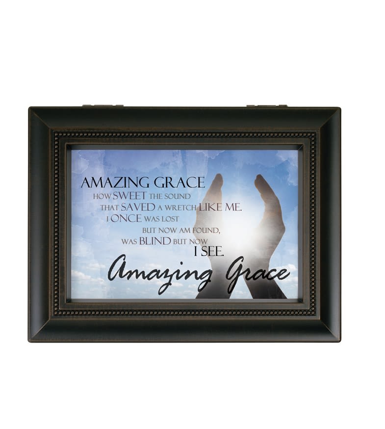 Framed wall art with the words Amazing Grace and raised hands