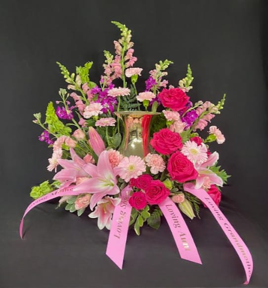 Always In Our Hearts Urn Design - Ease the mourning of the loss of a loved one with the stunning Always In Our Hearts cremation arrangement. Stargazer lilies, roses, and carnations in vibrant pink tones designed to surround the urn you have chosen for your loved one; perfect for celebrating the brilliant life of a special person. Arrangement is designed to hold a standard size urn. Urn not included.