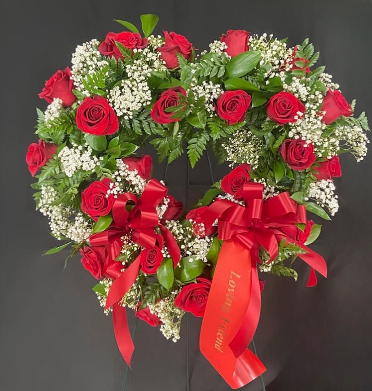 Heart-shaped red rose wreath with white baby's breath and red ribbons