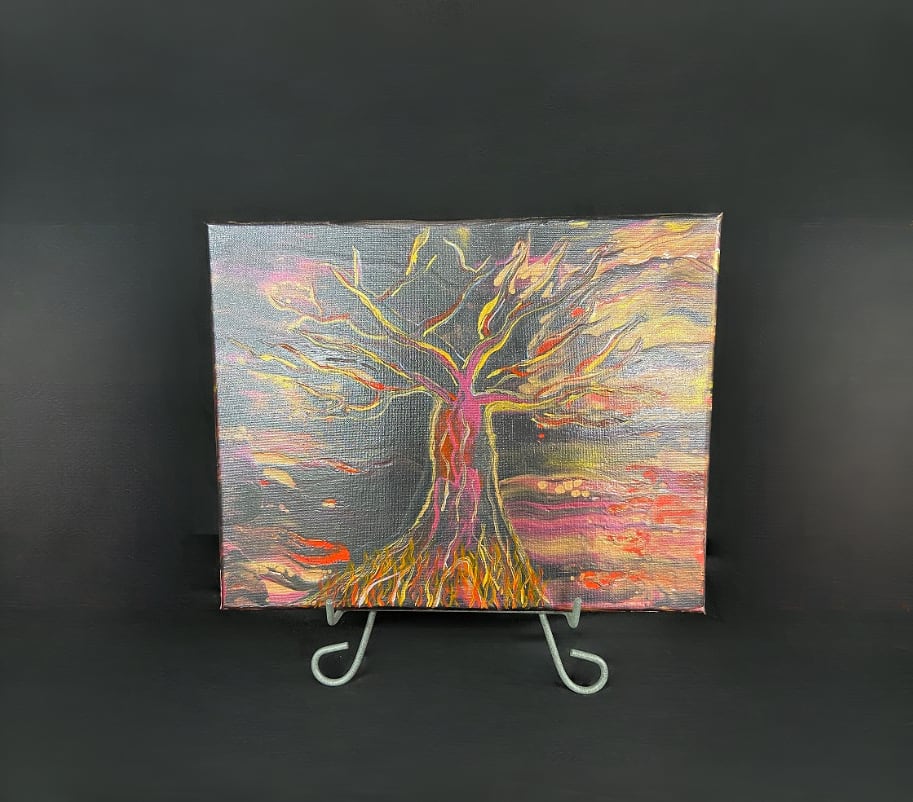 Abstract painting of a tree on a small display easel