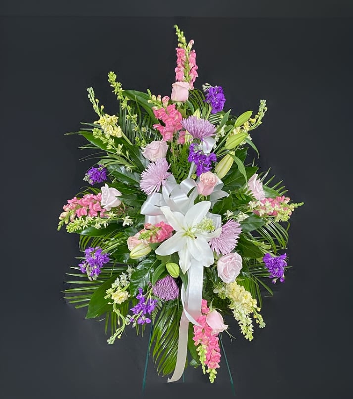 Pastel Farewell Standing Spray  - A mixed floral standing spray of Pastel colored flowers - Customizable to your needs. Arrangement is mounted on a 4.5ft standing easel for prominent display at funeral services.