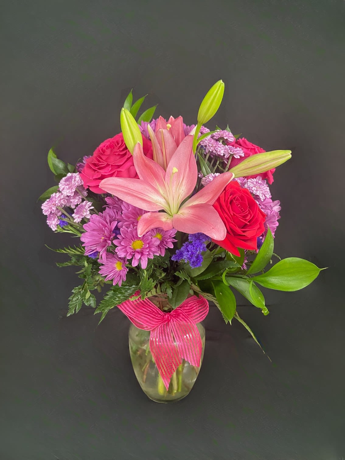 Perfect in Pink &amp; Red - Express your love with a gorgeous bouquet of red and pink roses, pink lilies, pink alstro, and assorted red and pink filler flowers.