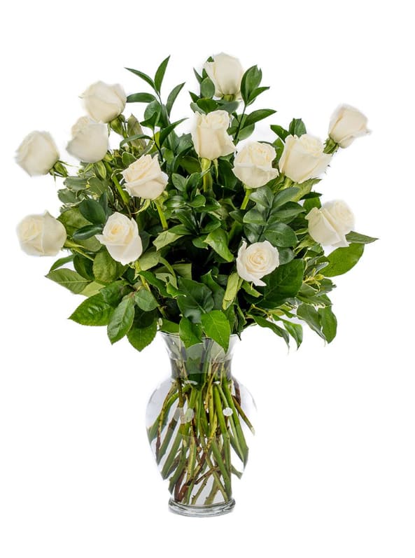 White roses arranged in a clear glass vase