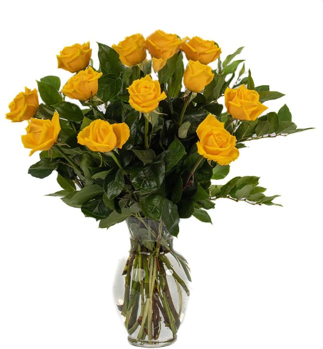 Yellow roses arranged in a clear glass vase