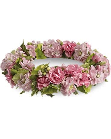 Pink floral wreath with green leaves on a white background