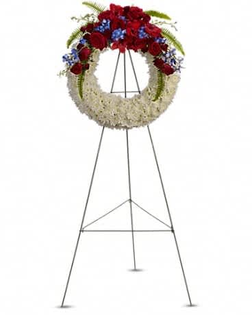 Floral wreath on a metal easel with red, white, and blue flowers