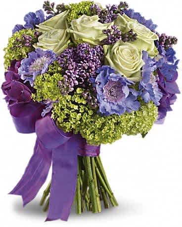 Bouquet of pale roses and purple flowers tied with a purple ribbon