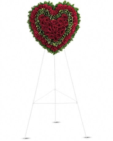 Heart-shaped floral standing spray on an easel