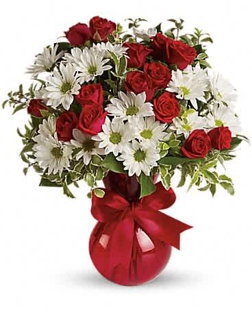 Red roses and white daisies in a red vase with a ribbon