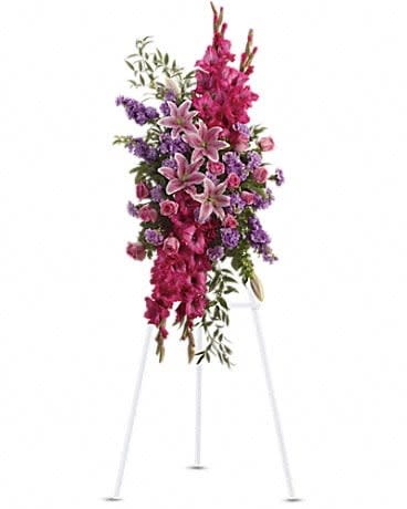 Tall pink and purple floral spray on a white easel