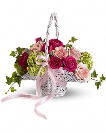 Basket of pink and red roses with green hydrangeas and a pink ribbon