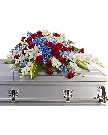 Red, white, and blue floral spray on a silver casket