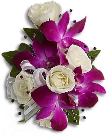 White roses and purple orchids arranged as a corsage