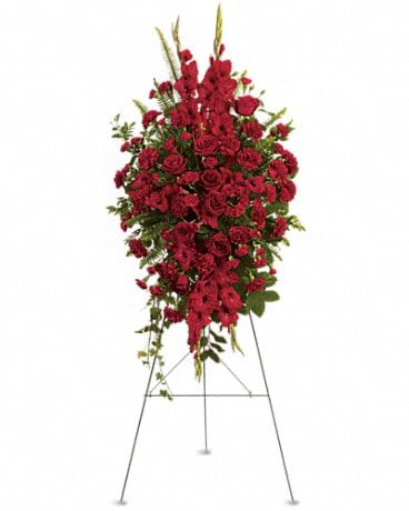 Standing spray of red roses and carnations on an easel