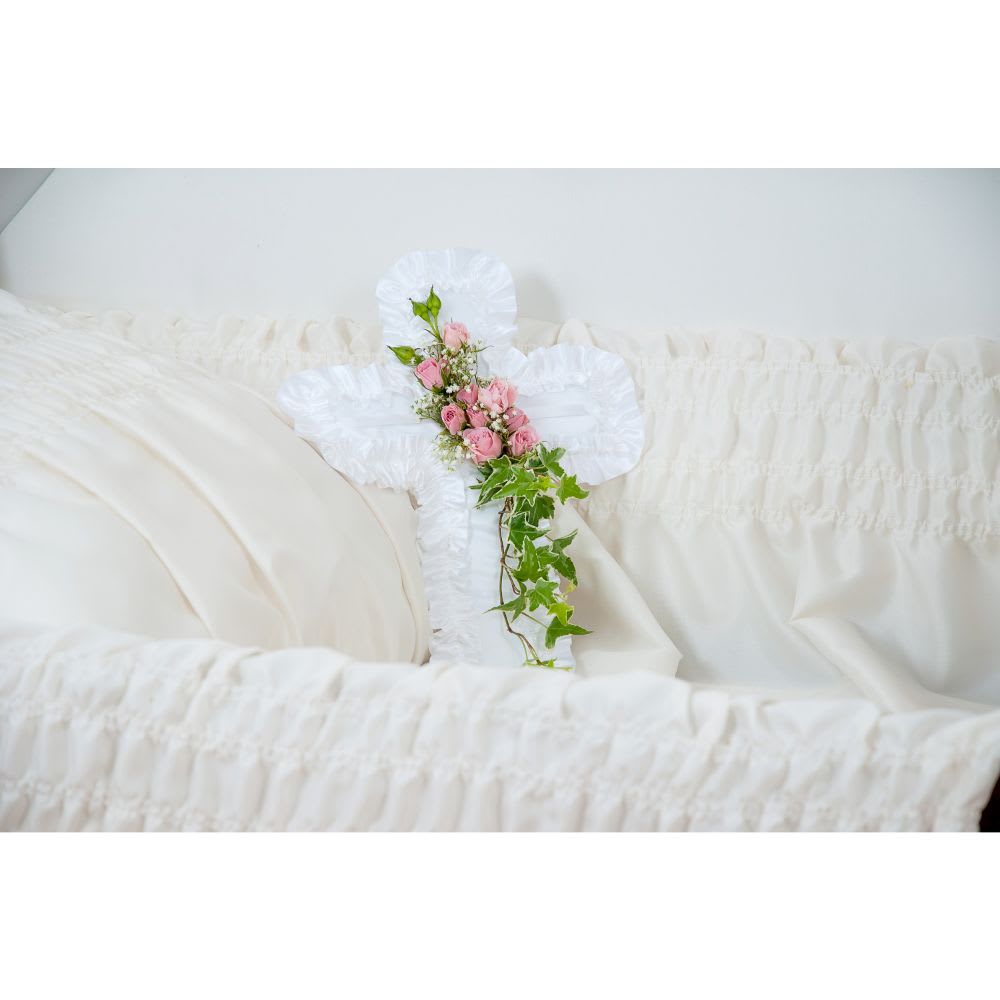 Cross Pillow - A satin cross pillow enhanced with a touch of flowers. Available in other colors. Specify choice in special instructions section. Also available in heart-shaped or rectangular pillow.  TMF816 