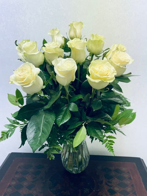 White Rose Serenity Bouquet  - The beauty of white roses is unchallenged. Representing innocence, their versatility makes them a favorite gift to offer your expression of love, congratulations or sympathy. 
