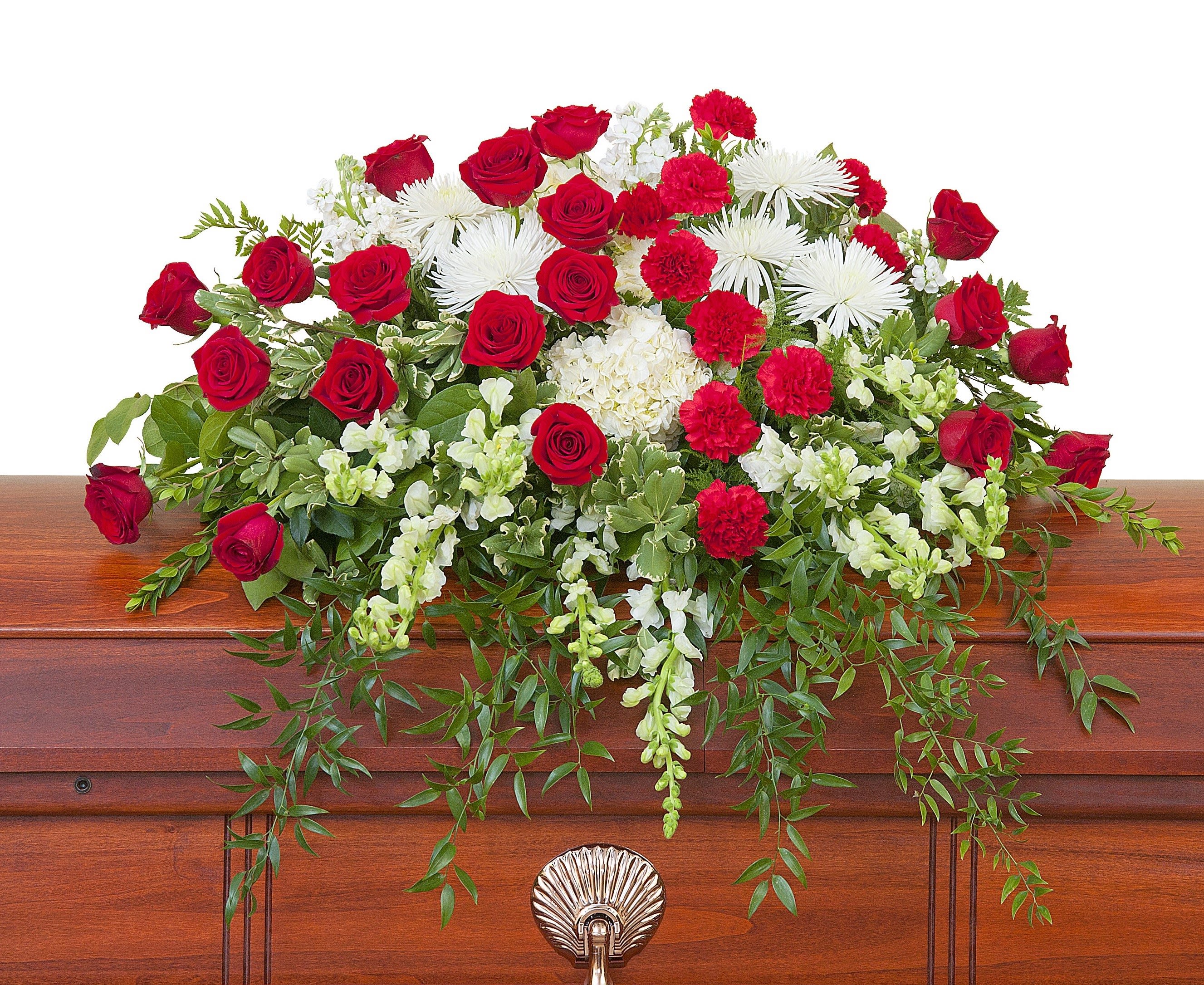 Red roses and white flowers arranged on a casket