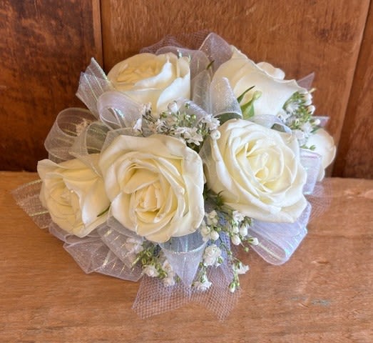 Bouquet of white roses with small white filler flowers and sheer ribbon wrap