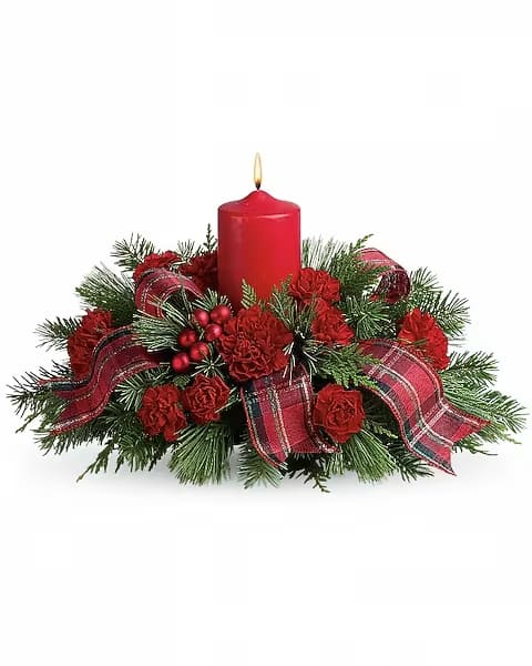 Red candle centerpiece with pine, red flowers, and plaid ribbon