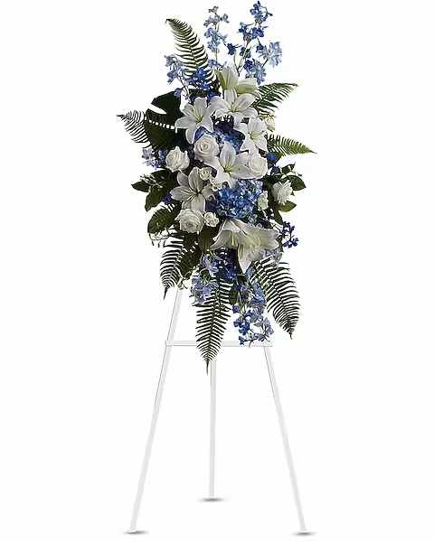 Tall white and blue floral standing spray on an easel