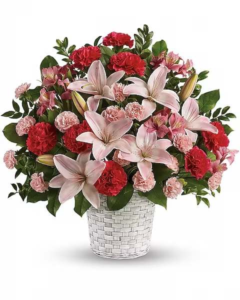 Pink lilies and red carnations in a white woven vase