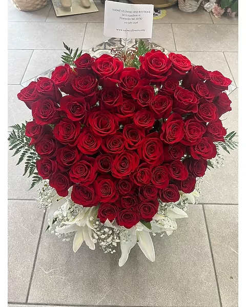 Large heart-shaped bouquet of red roses with white lilies