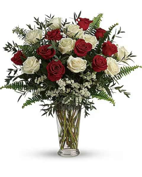 Red and white roses in a clear glass vase