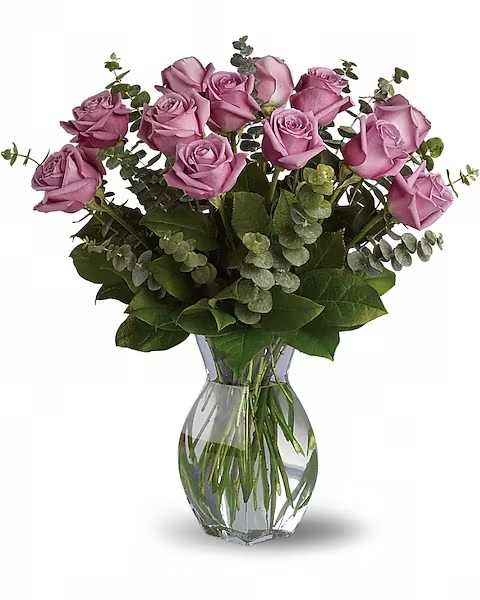 Lavender roses arranged in a clear glass vase