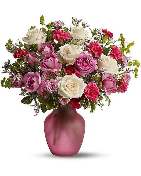 Bouquet of pink and white roses in a pink vase
