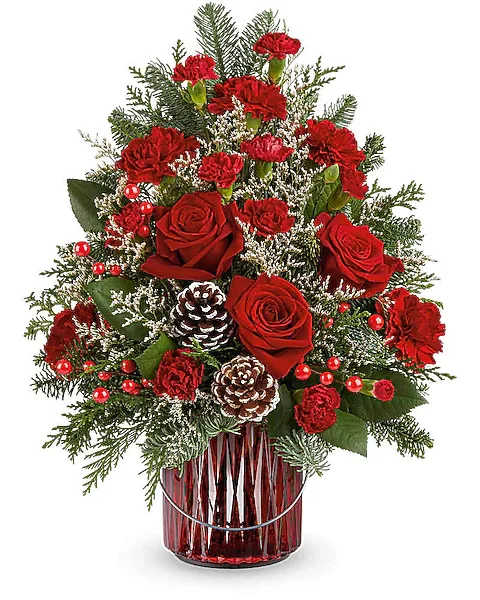 Red roses and carnations in a red glass vase with pinecones