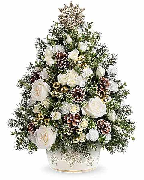 White roses and pinecones arranged in a Christmas tree shape in a decorative pot
