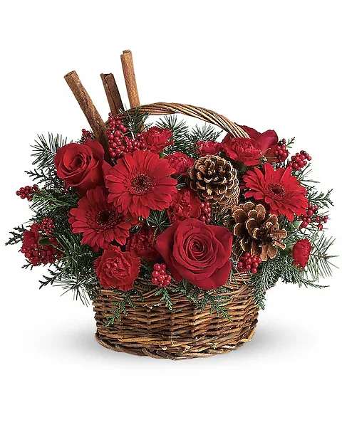 Red flowers and pinecones arranged in a wicker basket