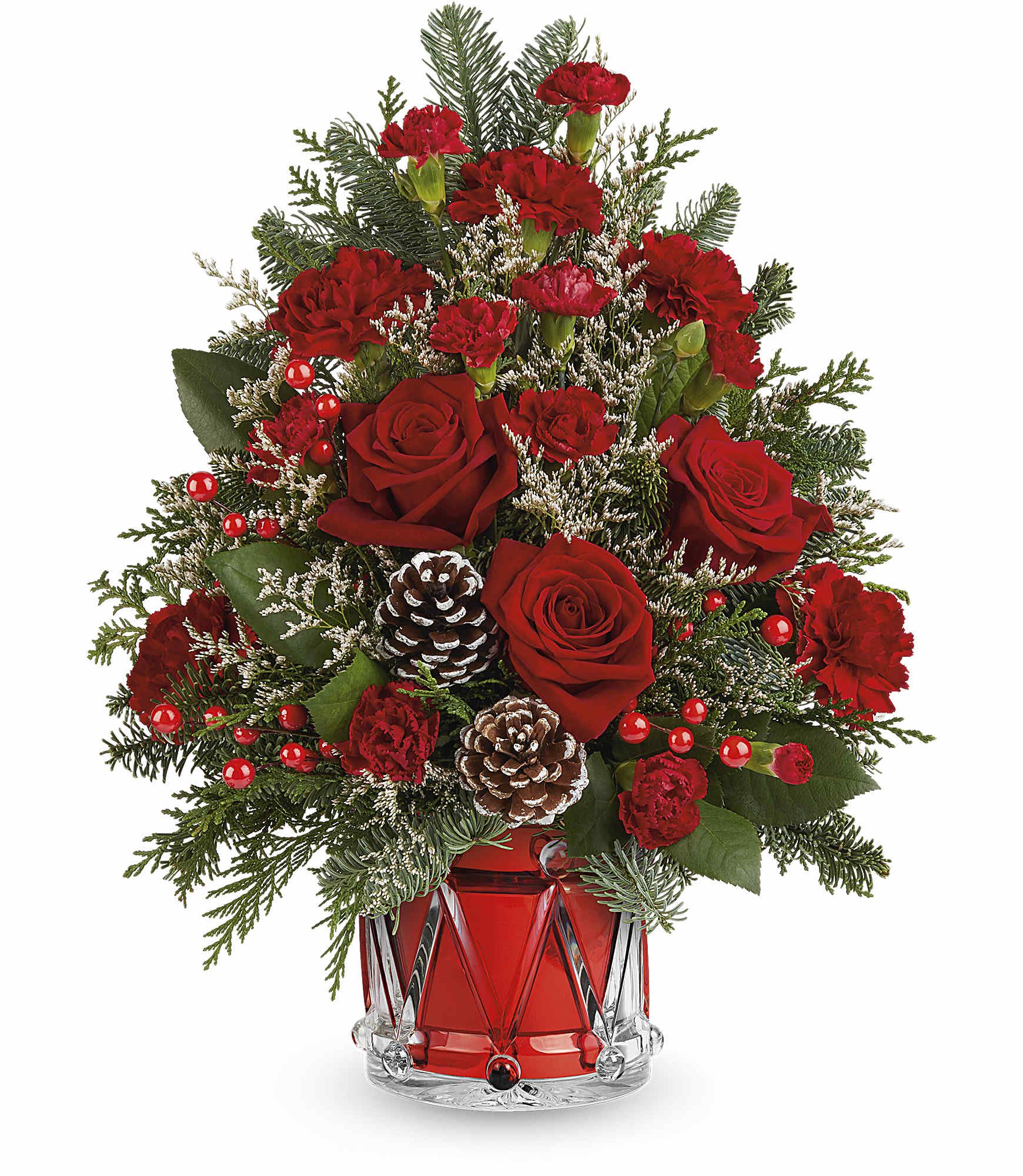 Red roses and carnations in a red glass vase with pinecones