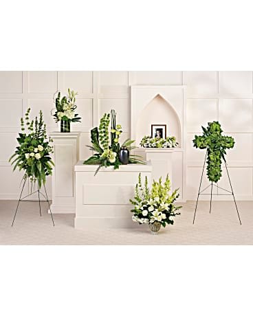 White and green floral funeral arrangements on stands and pedestals