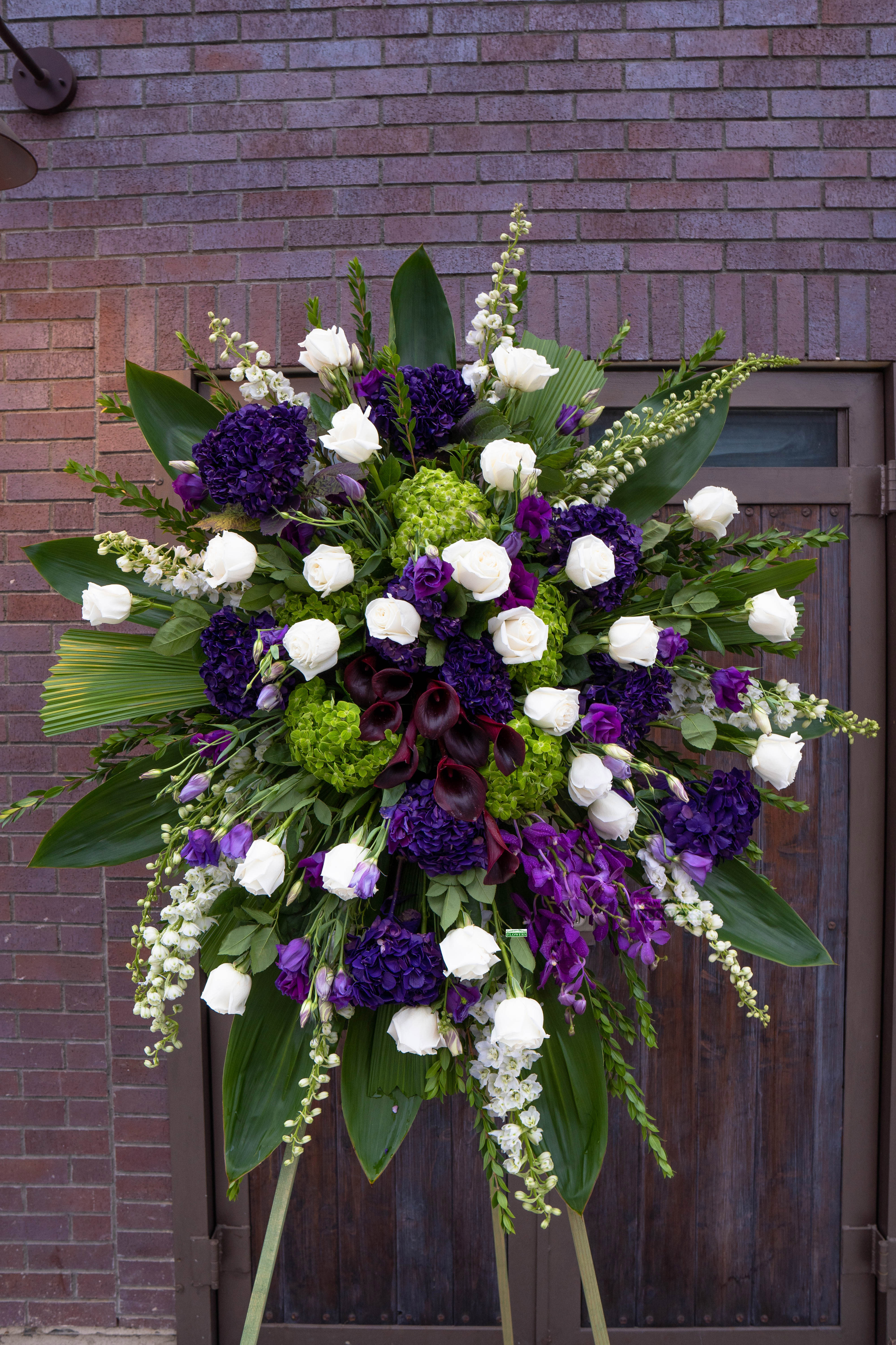 Large standing floral spray with white and purple flowers