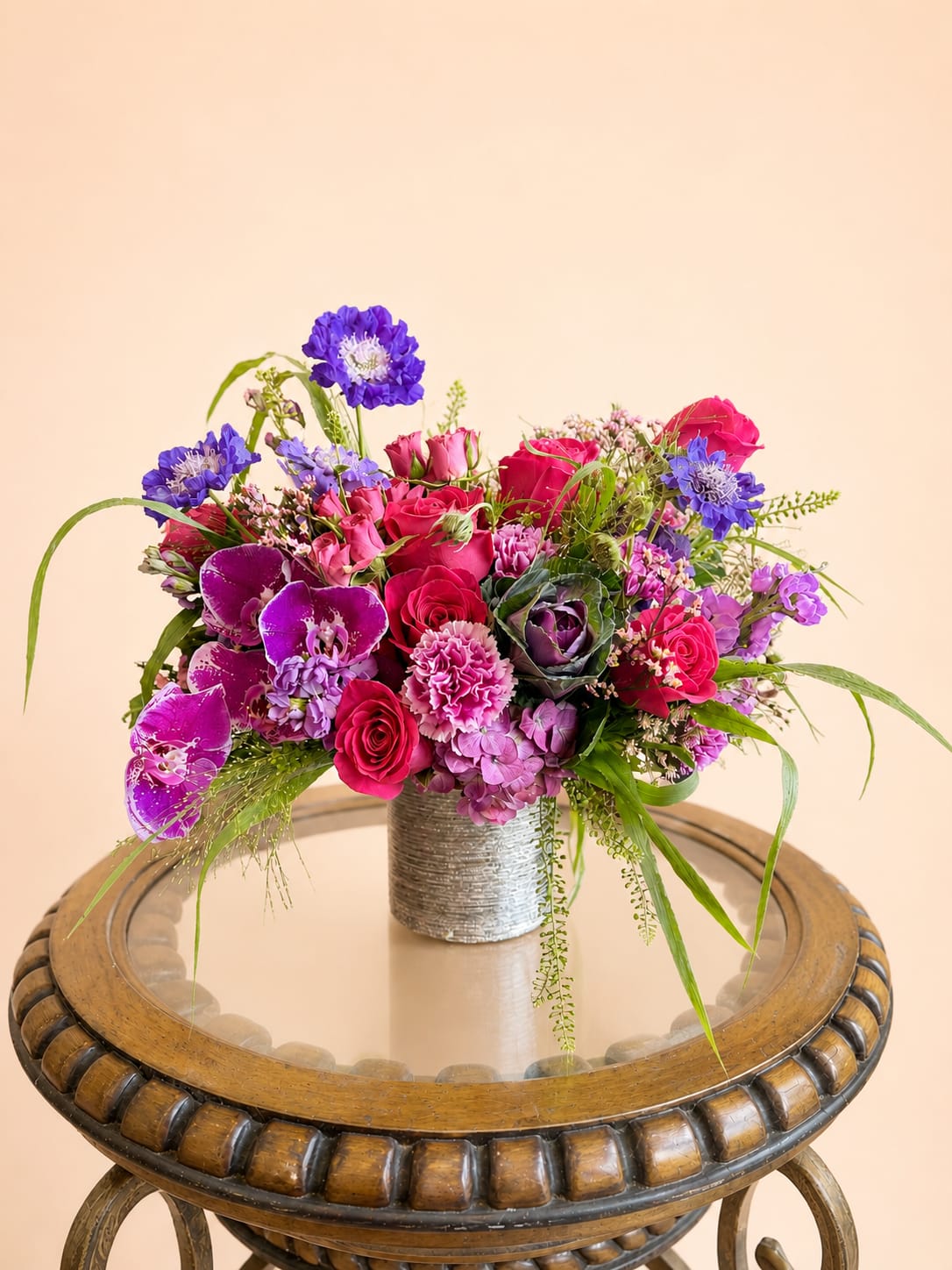For All She Does - A vibrant expression of love and gratitude, For All She Does is designed to celebrate the beauty, strength, and warmth of every mother. Featuring a lush blend of roses, orchids, and seasonal blooms in radiant shades of pink, indigo, and lavender, this arrangement is full of life and movement. Thoughtfully arranged in a modern vessel, it’s a heartfelt way to say thank you for everything she is and everything she does.