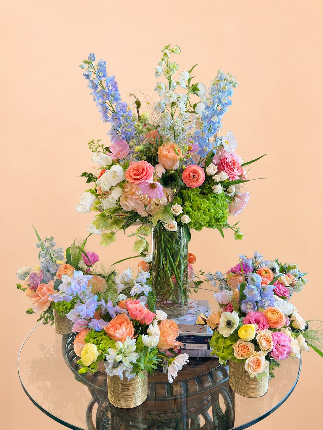 Summer Party Set - Bring effortless charm to your next gathering with our Summer Party Set. This curated package includes six small cheerful pastel arrangements &amp; one show-stopping large pastel centerpiece. Designed in soft, seasonal hues, these arrangements add the perfect pop of color and fresh elegance to any summer or spring celebration—whether it’s a garden brunch, bridal shower, or backyard soirée. Celebrate in style with blooms that capture the breezy beauty of the season!  1 tall arrangement: $175 5 small arrangements: $65 each 