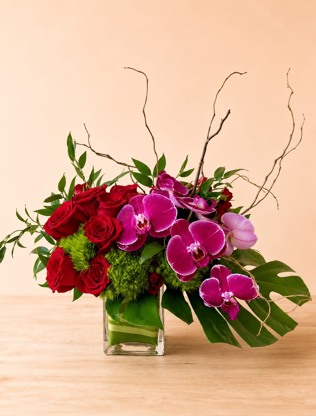 Love Sensation - Gorgeous one-sided arrangement roses, orchids, curly willow, and more.
