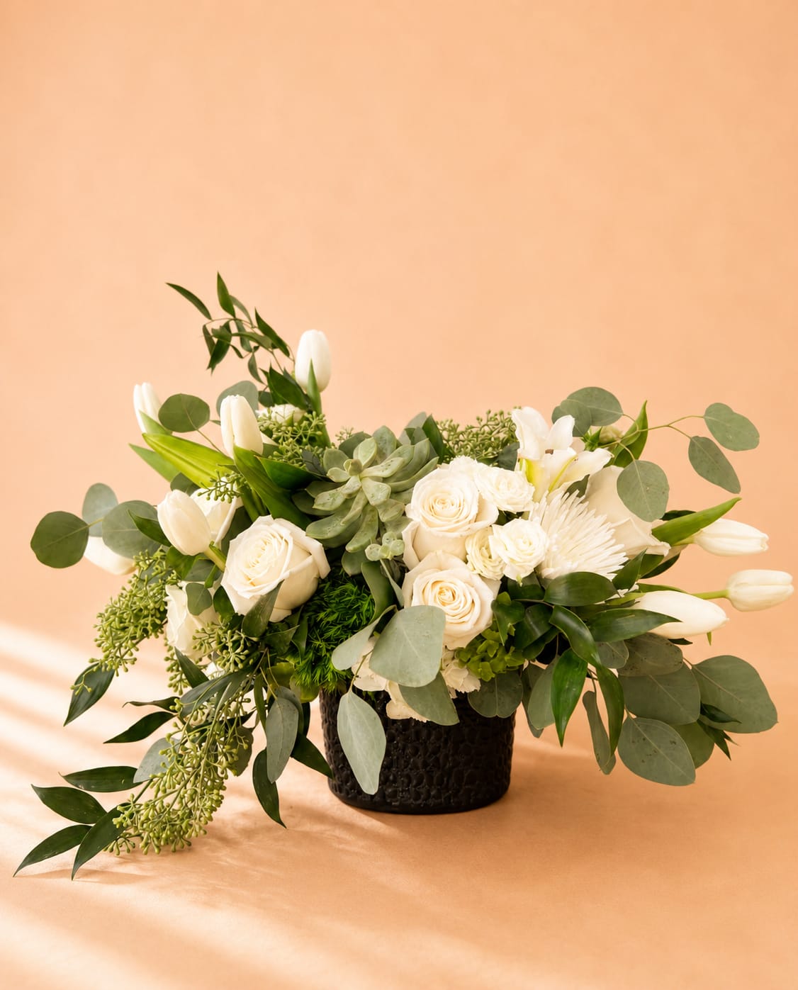 Snow White - Beautiful one-sided arrangement with a mixture of roses, orchids, greenery, and more.