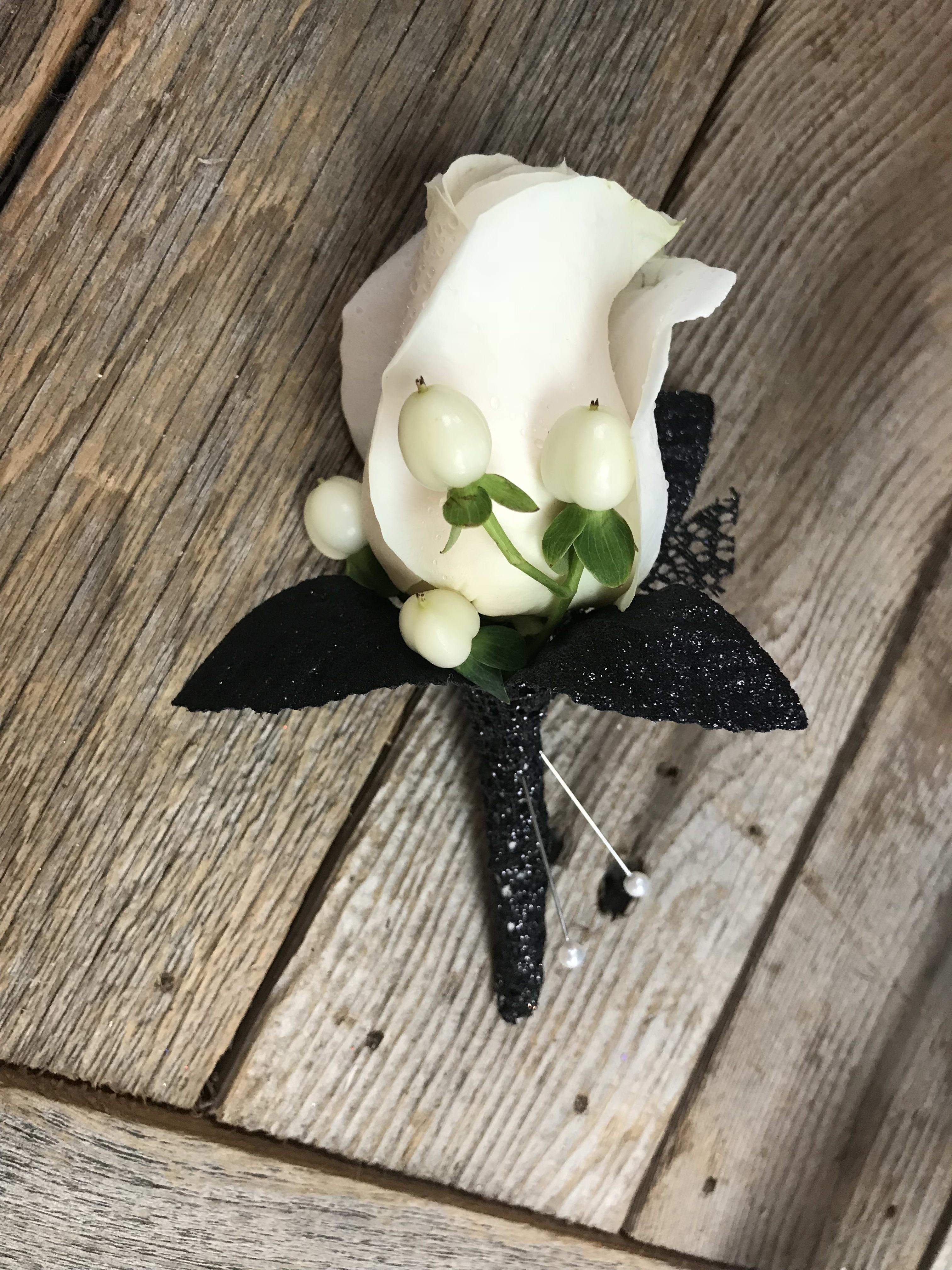 White rose boutonniere with black ribbon and pearl pins