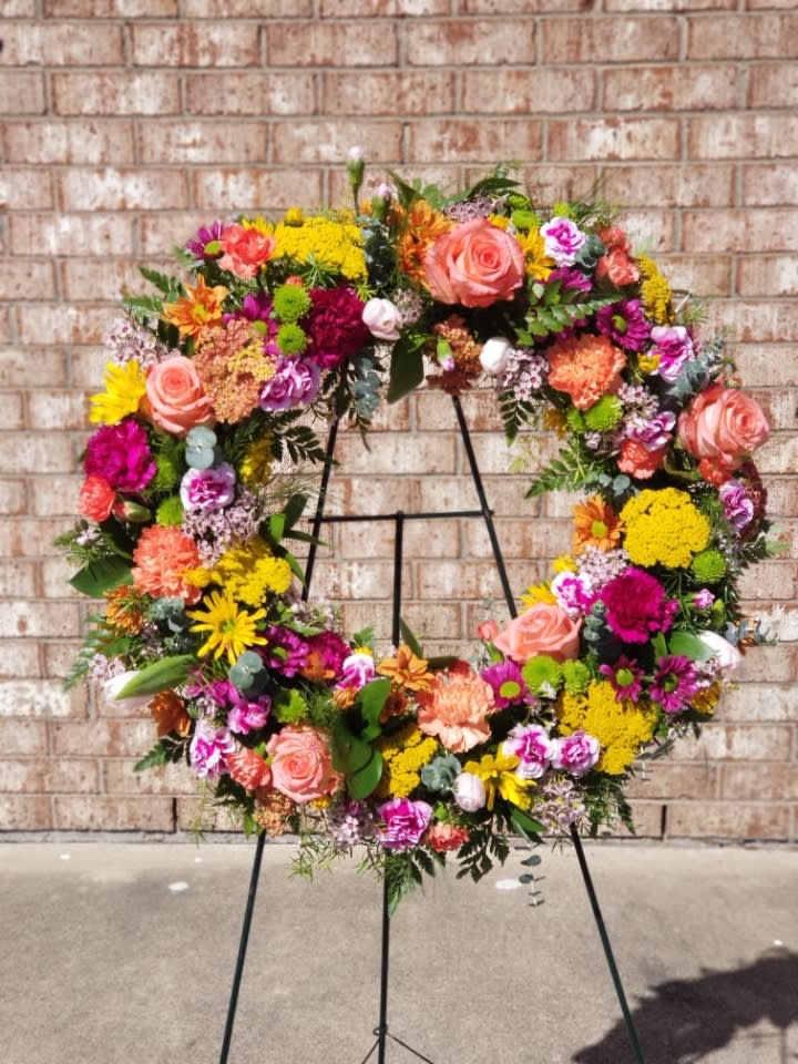 Ringed by Love - The memory of brighter days is always a comfort to those in mourning. This lovely wreath will display your compassion beautifully.  Standard- 18" wreath Deluxe-     22" wreath Premium-  24" wreath 