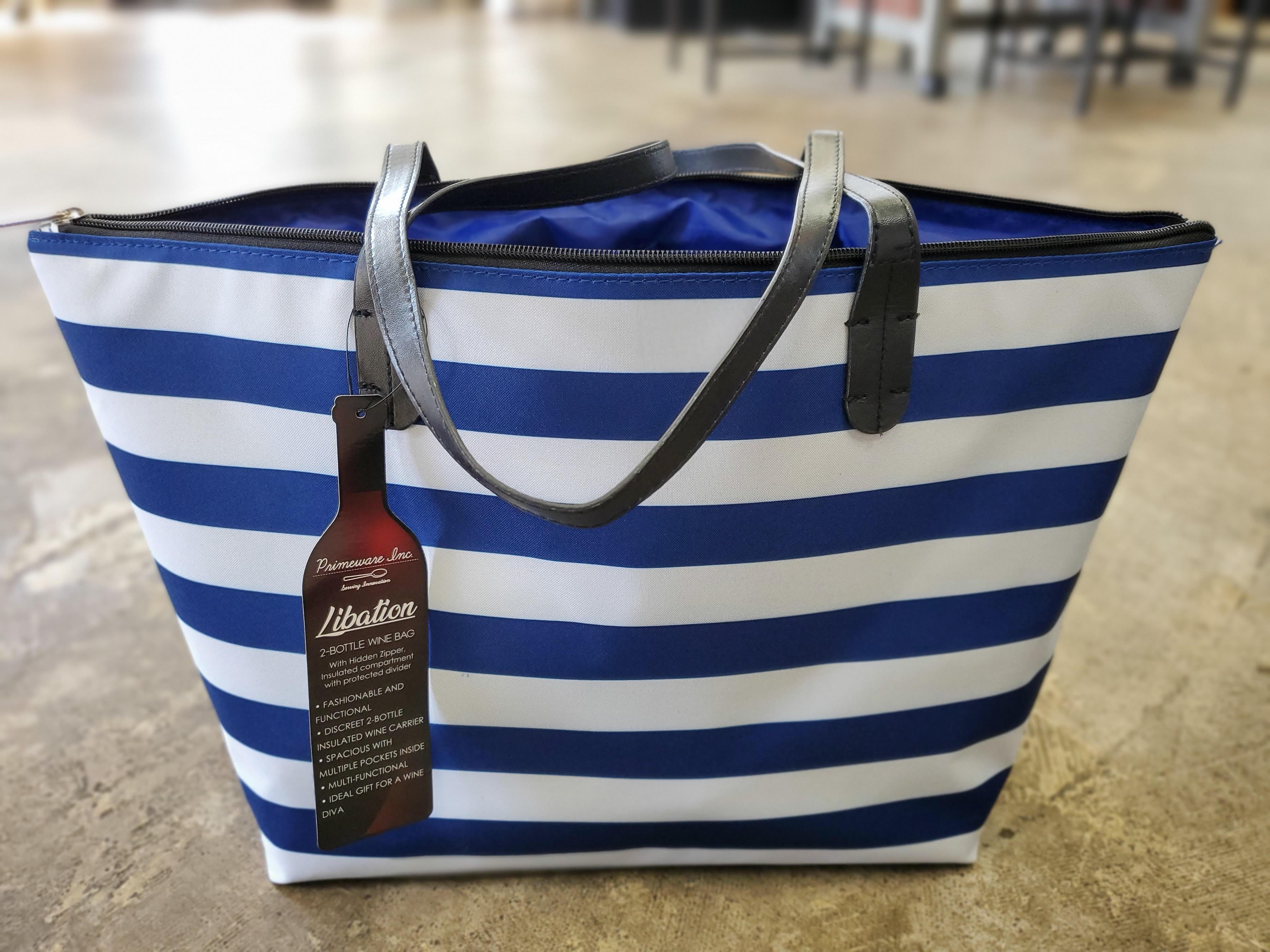Blue and white striped tote bag with black handles and a hanging tag