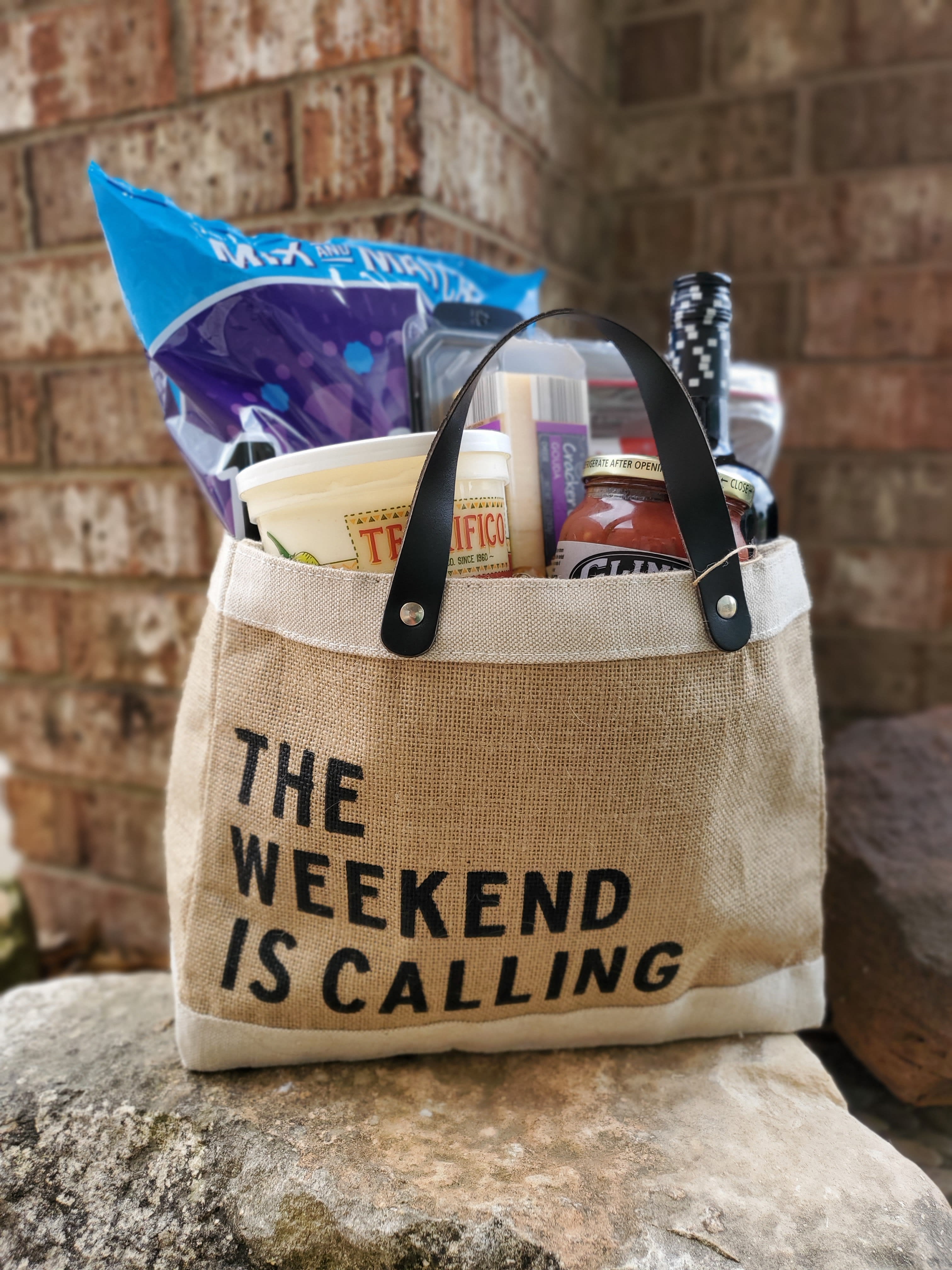 Gift tote filled with snacks and a bottle of wine