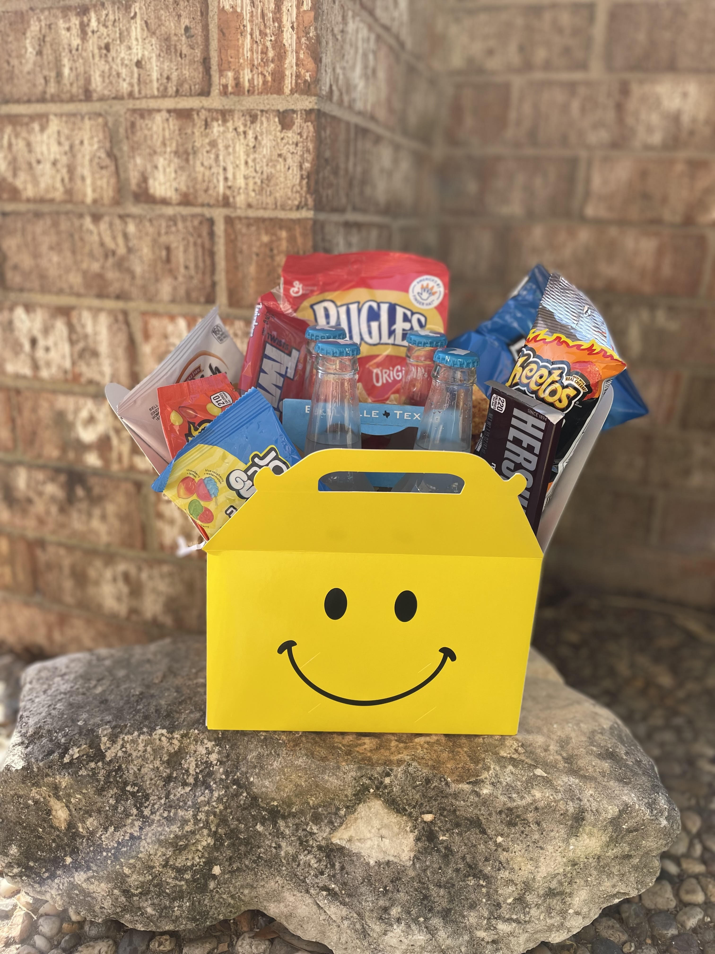 Yellow smiley-face gift box filled with candy and small soda bottles