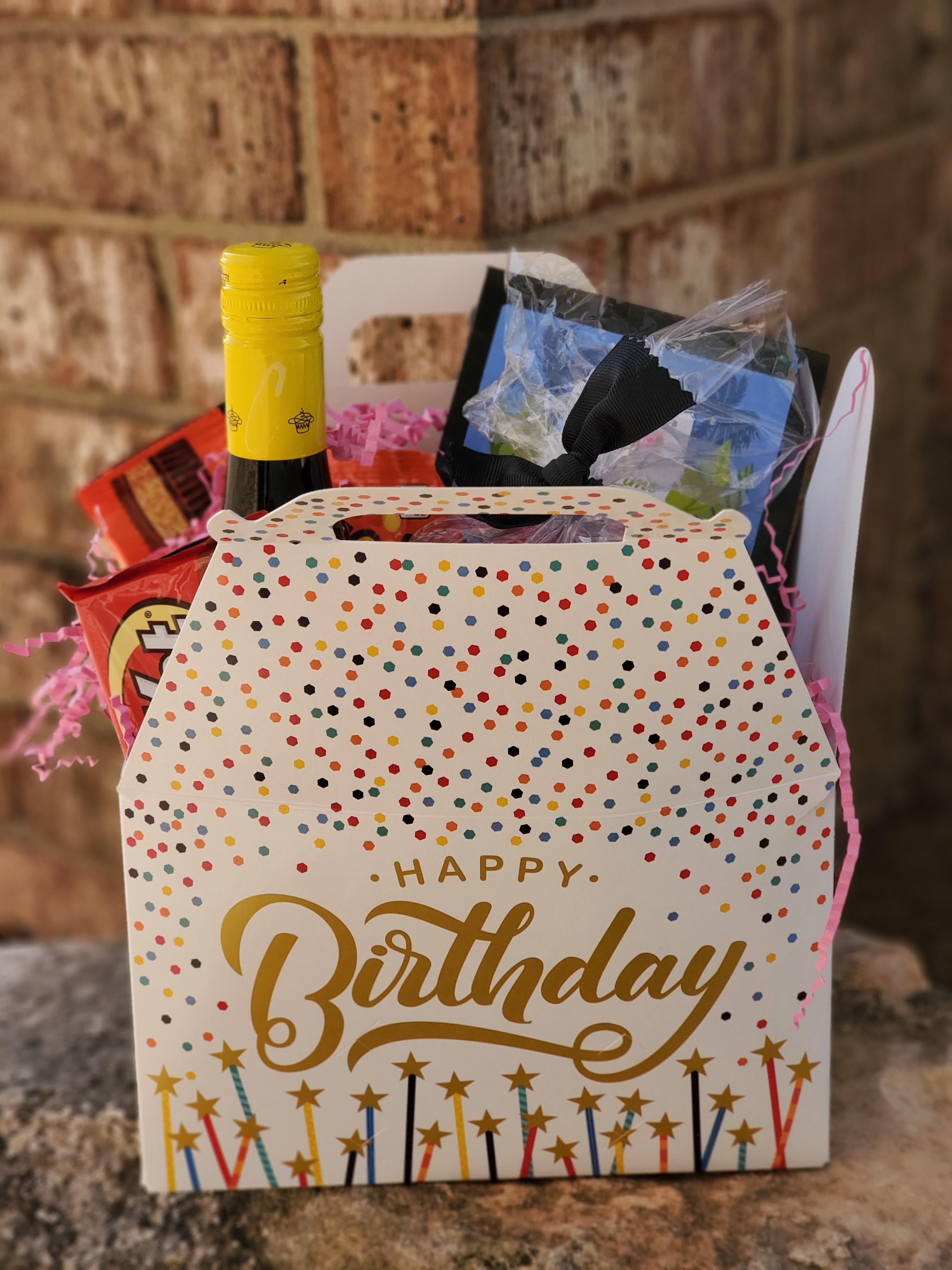 Birthday gift basket with wine, snacks, and a decorated box