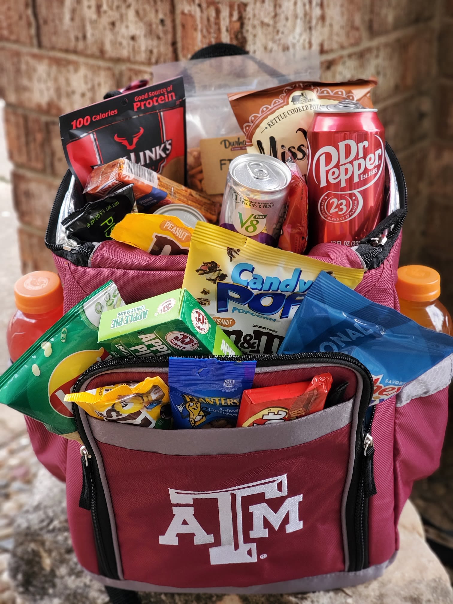 Texas A&amp;M cooler bag filled with assorted snacks and drinks
