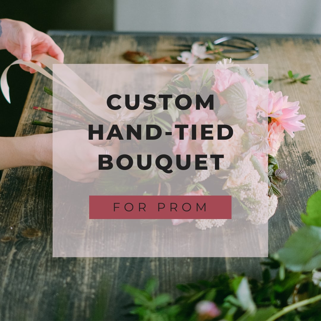 Hand-tied bouquet of pink flowers on a wooden table