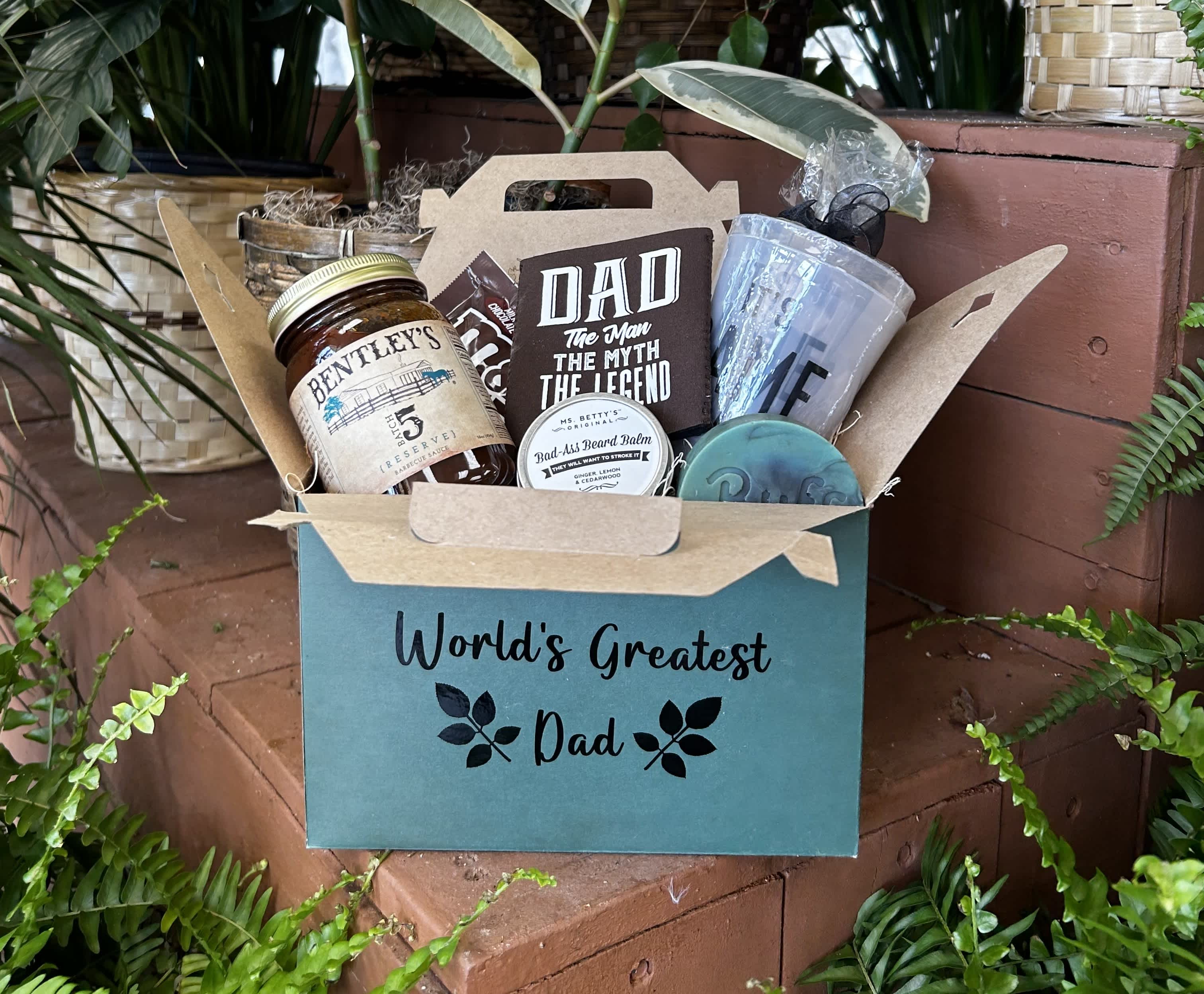 Gift basket with dad-themed snacks and grooming items in a teal box