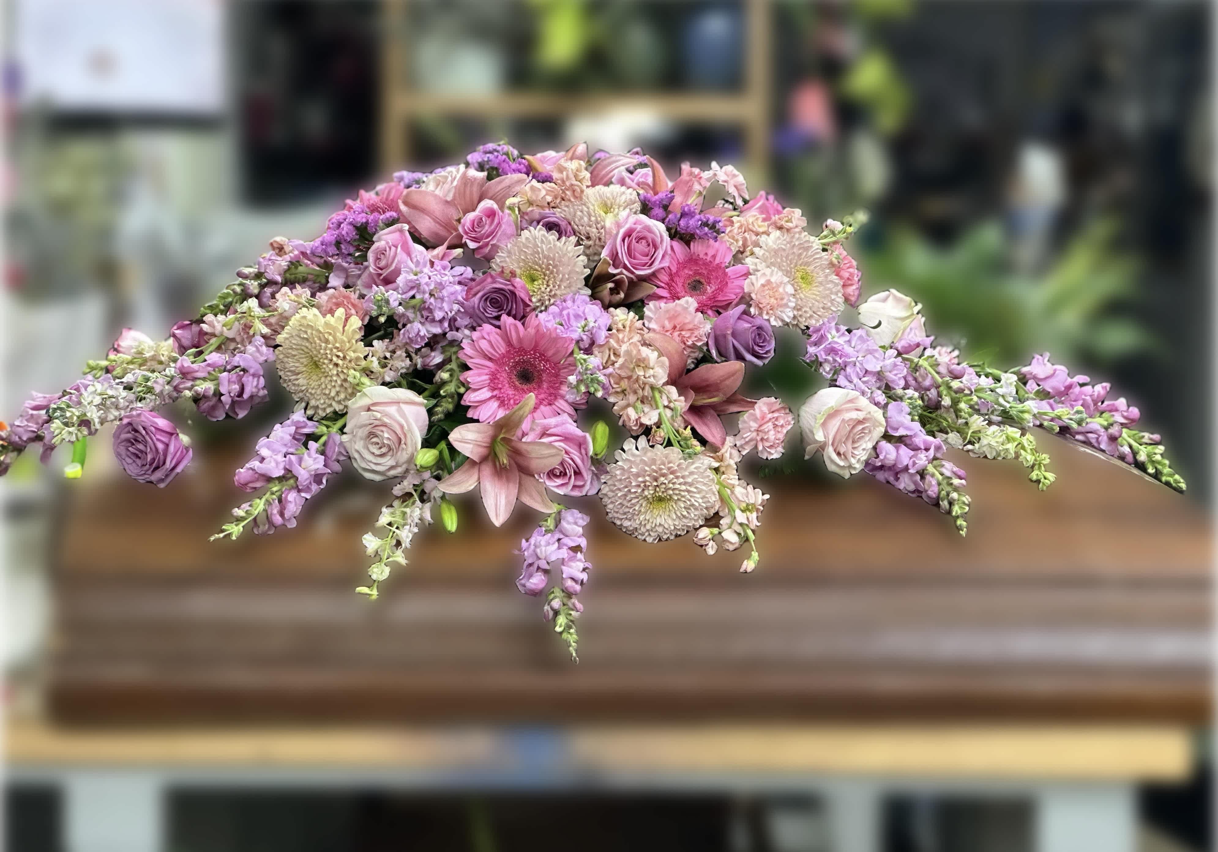 Casket spray of pink and lavender flowers